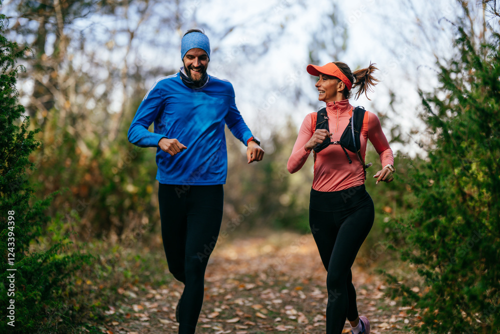 Fototapeta premium Happy Couple Running on a Forest Trail