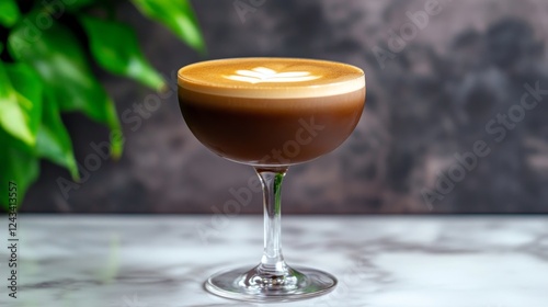 Espresso Martini Cocktail Drink - Close-up of an espresso martini, a delicious coffee cocktail, in a coupe glass.  The drink features a layer of espresso and a frothy, latte art-style topping. photo