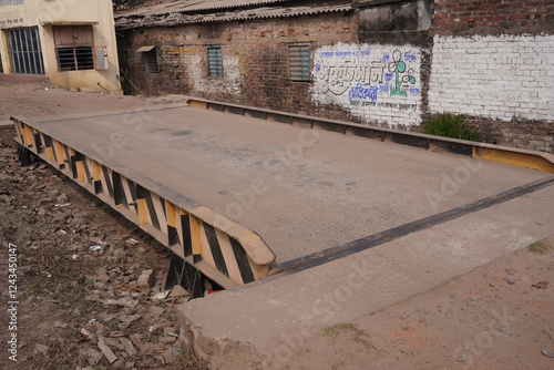 A weighbridge or truck scale which is used for weighing entire road vehicles and their contents photo