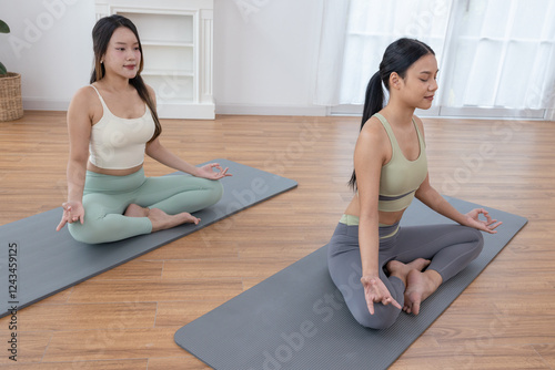 Wallpaper Mural Teenage girls practicing yoga poses, trainer stretching muscles in the morning at home Torontodigital.ca