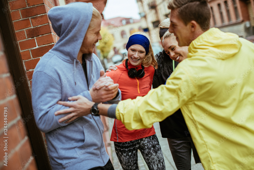 Fototapeta premium Young people stretching and getting ready to go jogging in the city