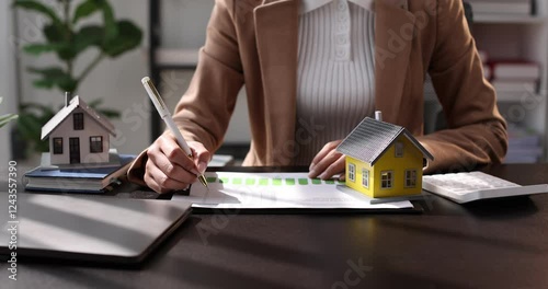 Female woman hands holding home model, small miniature white toy house. Mortgage property insurance dream moving home and real estate concept