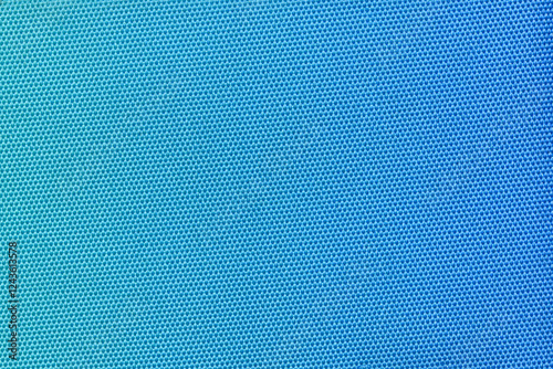 A vibrant blue fabric with a tight honeycomb pattern, creating a modern and clean texture. Ideal for use in fashion, interior design, or as a versatile background element. Blue gradient.