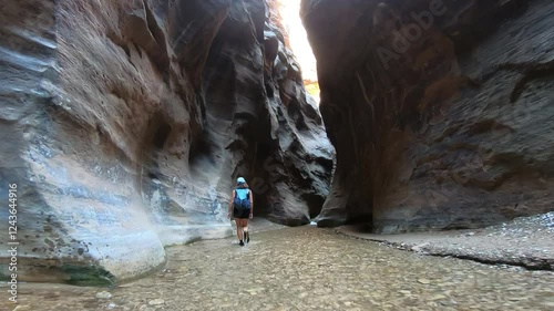Immersive hiking experience at Zion National Park’s Narrows trail, featuring serene river crossings and rugged canyon walls.