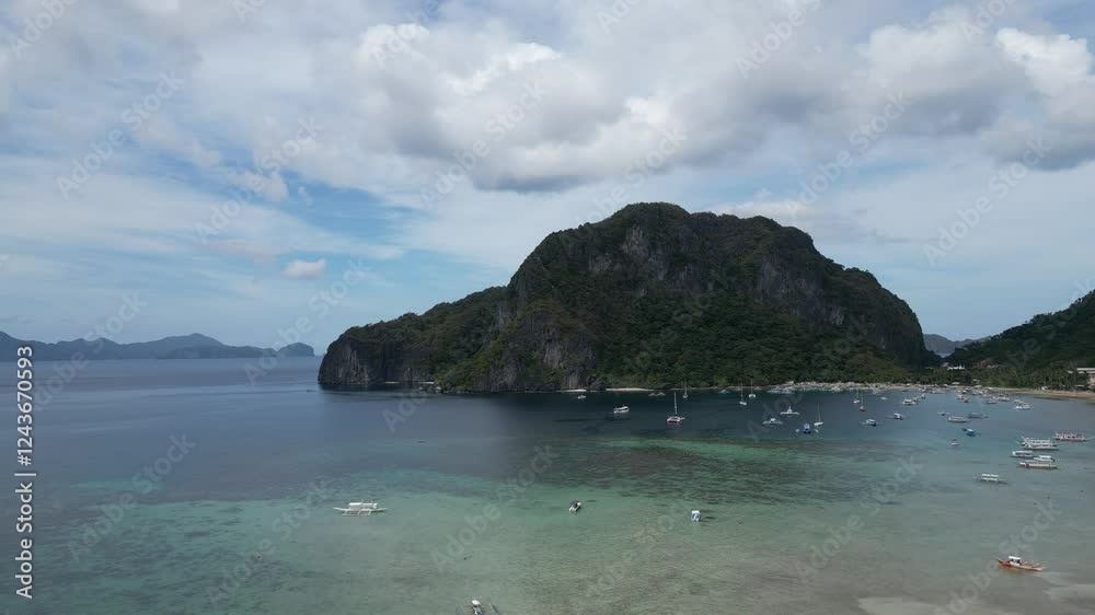 A breathtaking aerial view of El Nido, Palawan, Philippines, featuring lush green mountains, turquoise waters, limestone cliffs, and a coastal town. A breathtaking aerial view of El Nido, Palawan, Philippines, featuring lush green mountains, turquoise waters, limestone cliffs, and a coastal town.