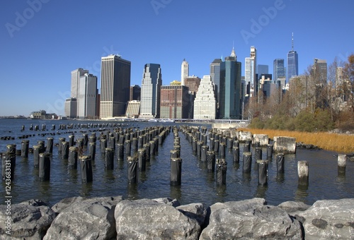Old Pier One pilings at Brooklyn Bridge Park, Brooklyn, New York. Image of Lower Manhattan and the old pilings taken on a clear, December morning.