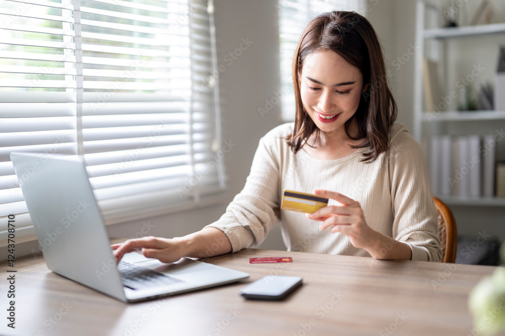 A woman is using a laptop to pay for something with a credit card A woman is using a laptop to pay for something with a credit card