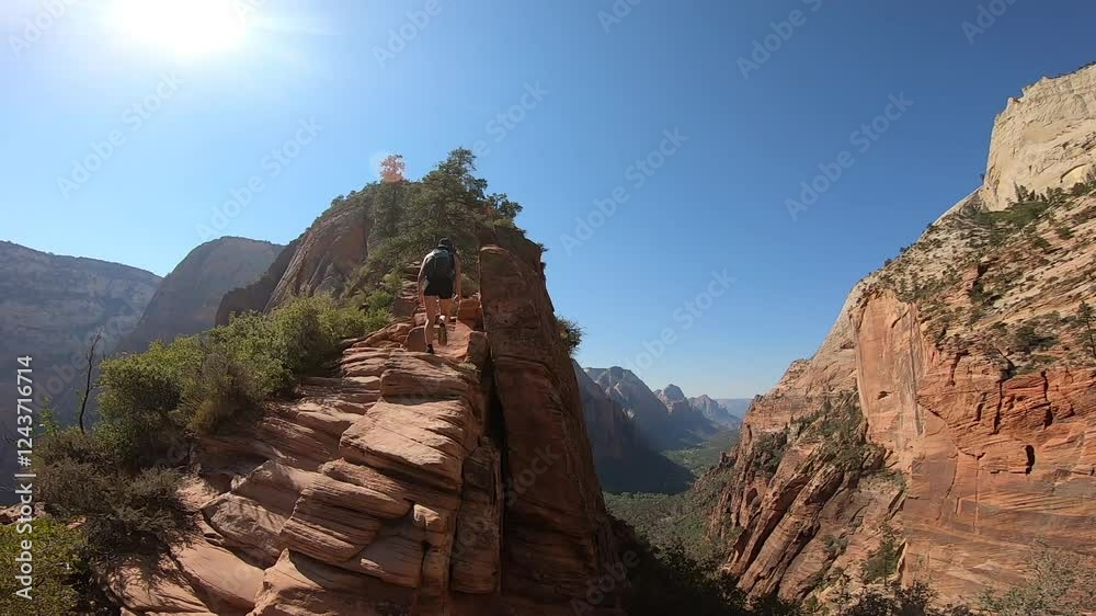 Wide-angle shot of the Angels Landing hike at Zion National Park, highlighting the dramatic landscape of towering cliffs and blue skies.