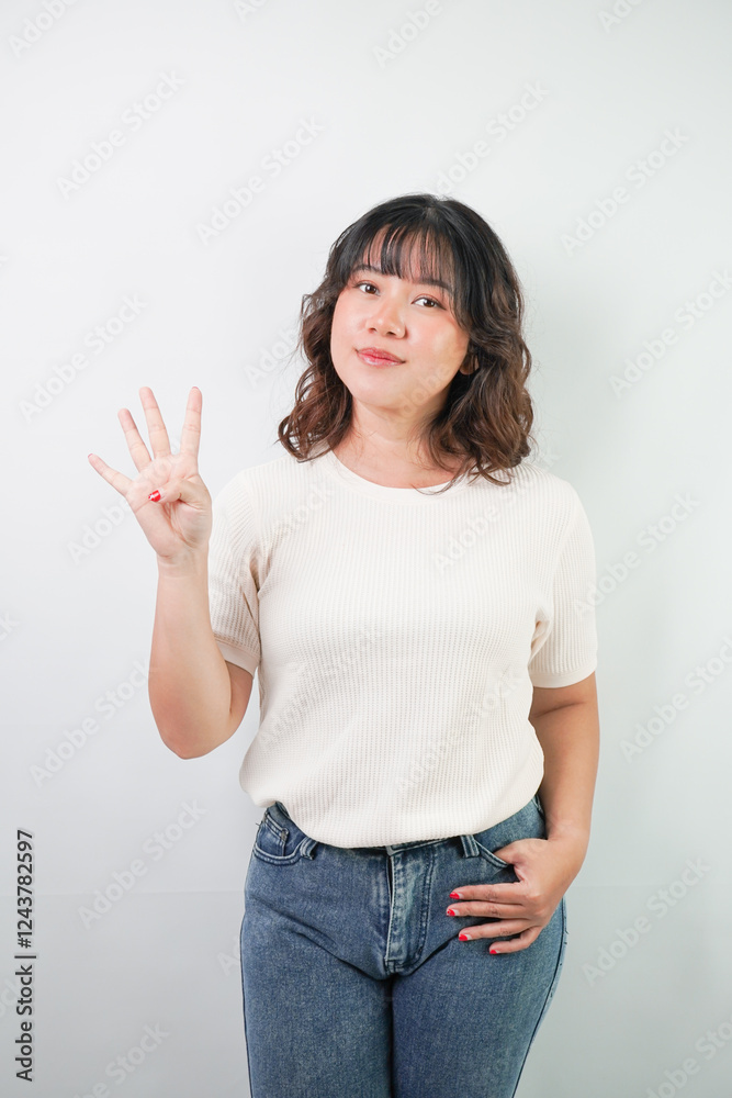 Beautiful young asian woman with wavy hair wearing white shirt is showing number 4 hand gesture, isolated over white background. Beautiful young asian woman with wavy hair wearing white shirt is showing number 4 hand gesture, isolated over white background.