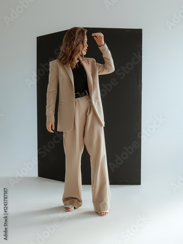 Natural look. Beauty model woman . Model test portrait with young beautiful fashion model posing on dark grey background. Blond woman in a biege blazer . Natural makeup