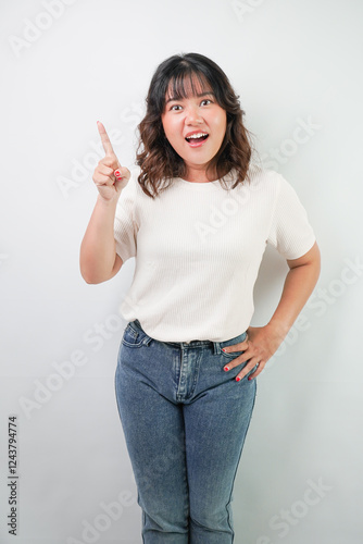 Fotografie Beautiful young asian woman with wavy hair wearing white shirt is showing rejection hand gesture, isolated over white background