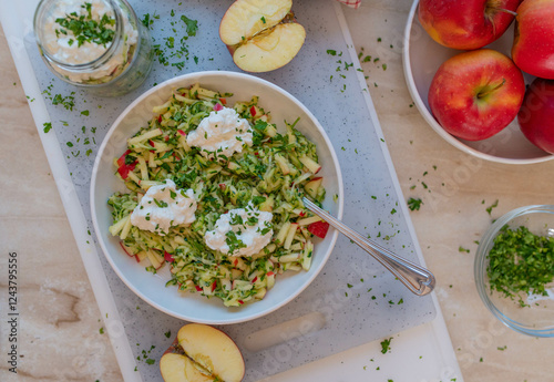 Healthy raw fruit vegetable salad with apples and zucchini topped with protein rich cottage cheese