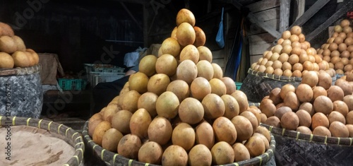 chinese food marketLandscape photo of a pile of ripe sapodilla fruit with a distinctive brown color  photo