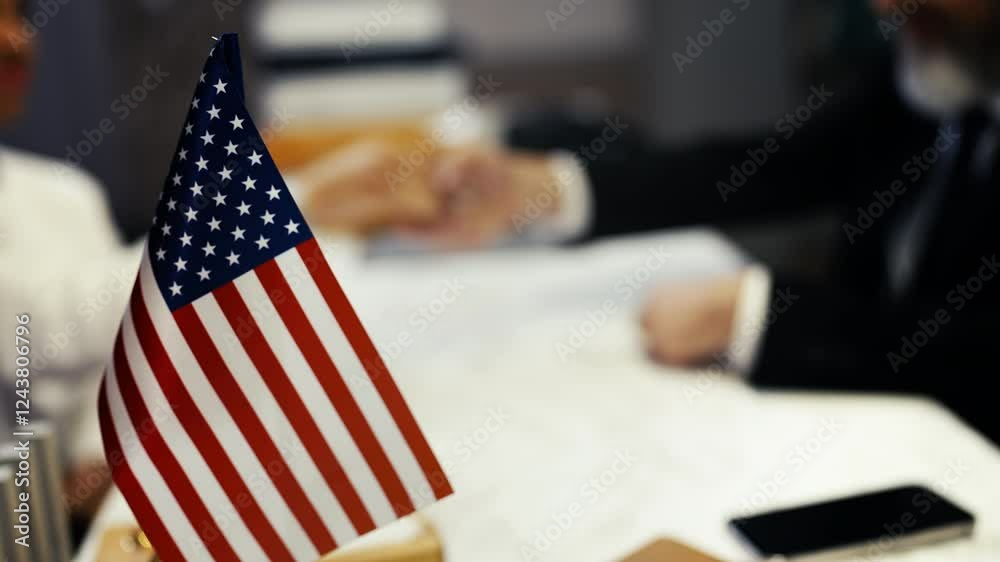 U.S. official hands a passport to a woman, approving her visa application