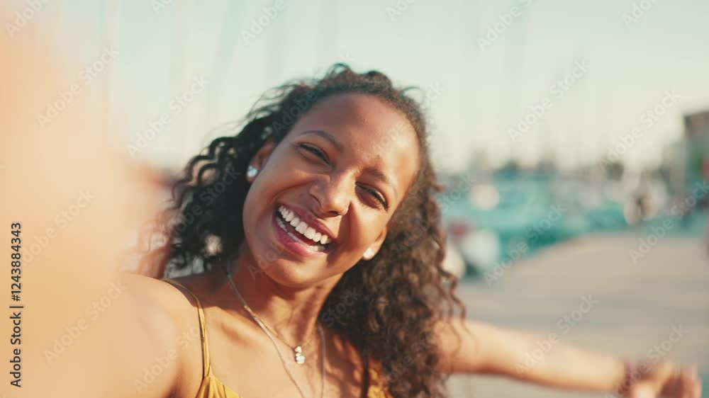 Close-up portrait of smiling girl with long curly hair chatting on the embankment, on yacht background. Frontal closeup of happy young woman using mobile phone Close-up portrait of smiling girl with long curly hair chatting on the embankment, on yacht background. Frontal closeup of happy young woman using mobile phone