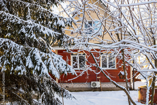 vew of small wooden cottage from snowy backyard photo