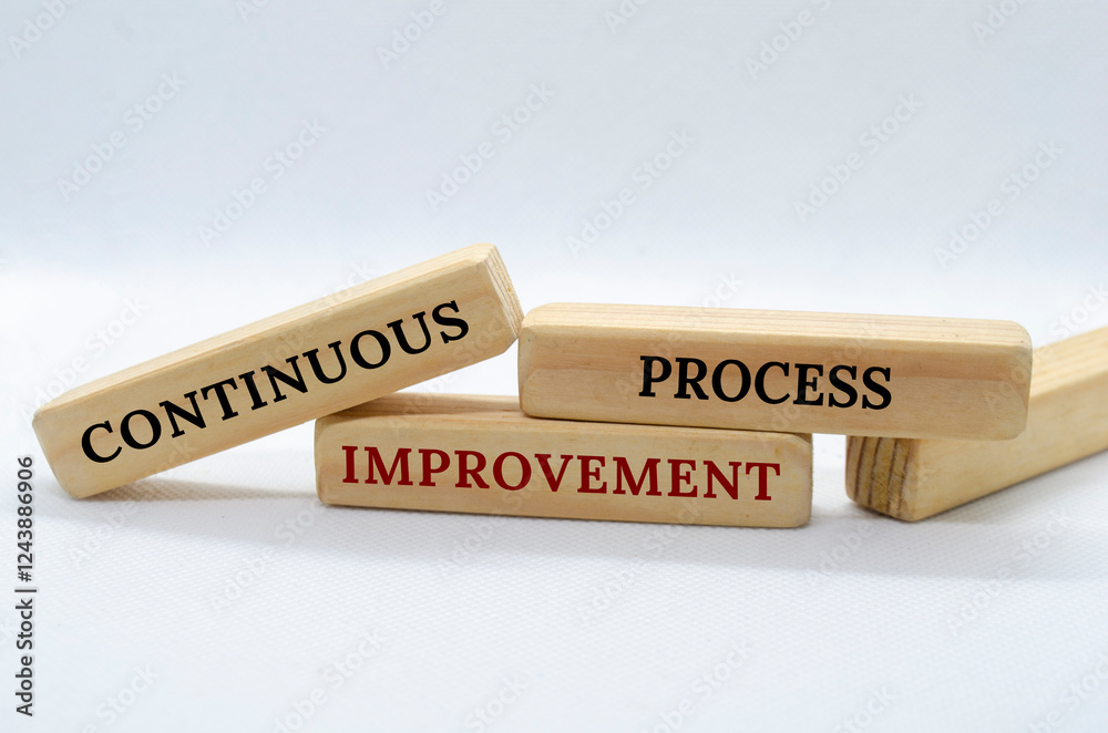 Obraz premium Continuous Process Improvement text on wooden blocks with white background. Process Improvement concept