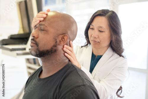 Doctor looking at patients neck photo