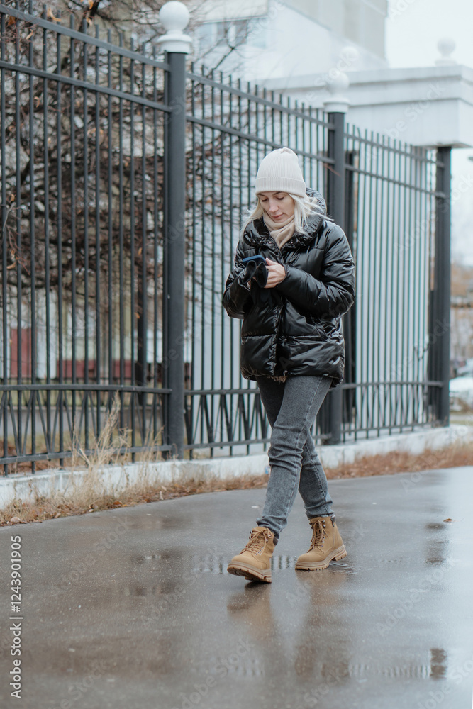 A beautiful young woman walks through a snowy city on a winter day, joyfully chatting on her phone. She smiles and laughs, radiating warmth and happiness. The clip captures a cozy lifestyle vibe A beautiful young woman walks through a snowy city on a winter day, joyfully chatting on her phone. She smiles and laughs, radiating warmth and happiness. The clip captures a cozy lifestyle vibe