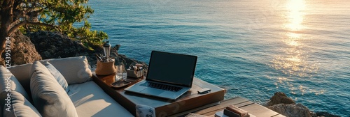 Laptop and coffee with ocean view outdoor workspace.