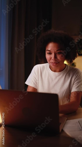 Pretty freelancer working on laptop checking email surfing web late at night indoors Focused young african american woman student having online distance education or work on computer at home workplace