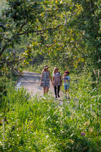 Family walking along a trail in a park