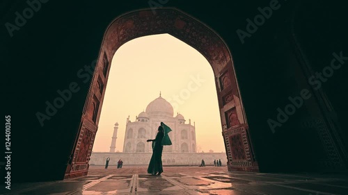 A woman in an Indian sari dancing in slow motion at the Taj Mahal, India