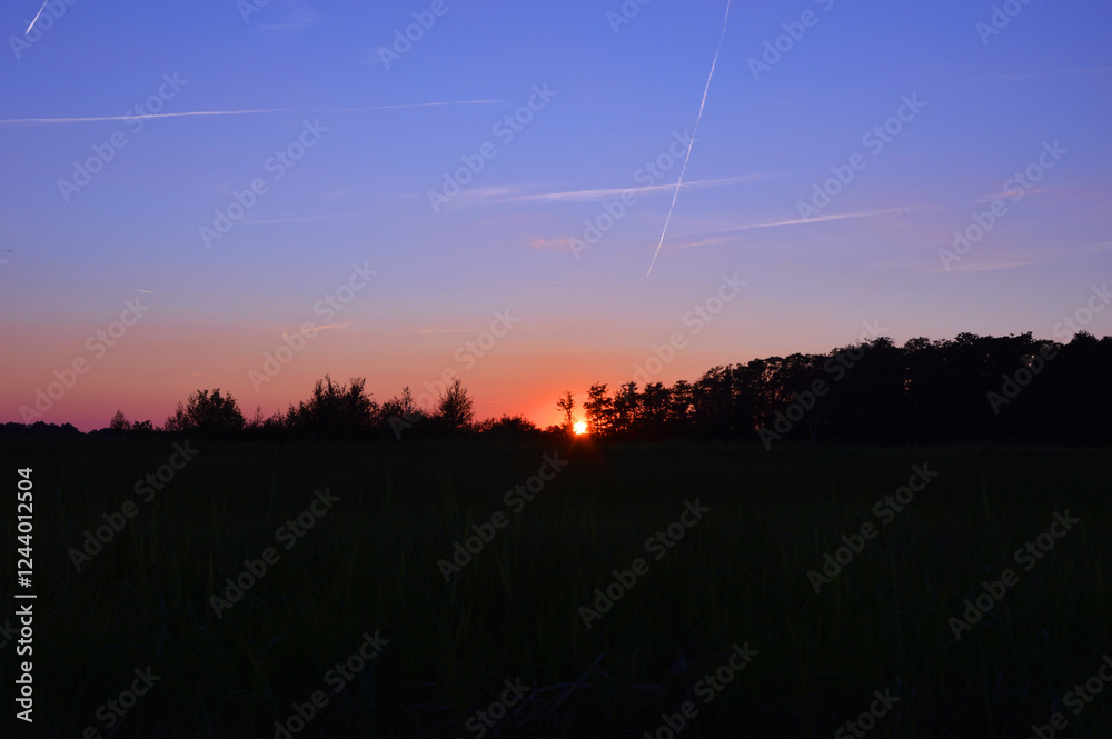 Beautiful blue orange twilight sky over the fields Beautiful blue orange twilight sky over the fields