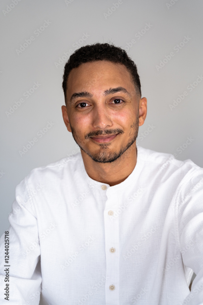 Young man smiling and posing for a portrait in white shirt Young man smiling and posing for a portrait in white shirt