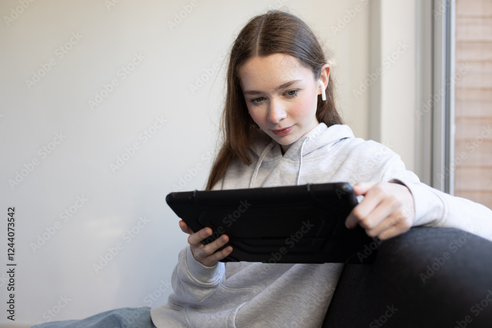 Girl sitting on sofa with laptop Girl sitting on sofa with laptop
