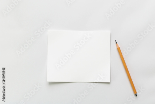 White paper with pencil in minimalist style with copy space for text or notes against a clean background