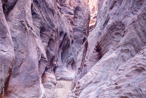 Narrow Slot Canyon with Purple Sandstone Walls in Utah Desert