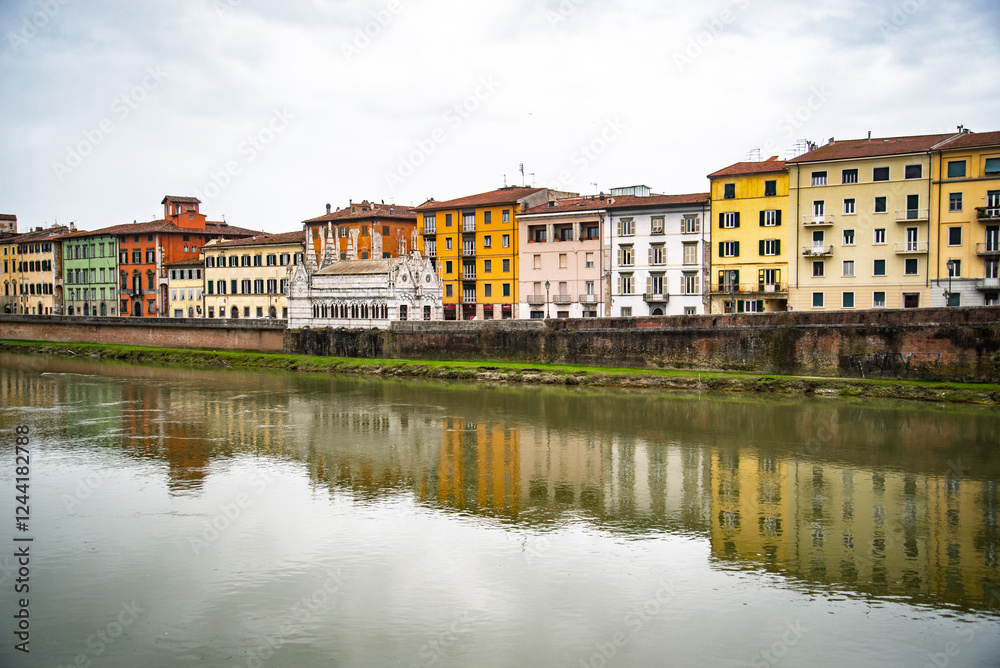 View on Arno river and colorful building, reflection in water, Pisa, Italy View on Arno river and colorful building, reflection in water, Pisa, Italy