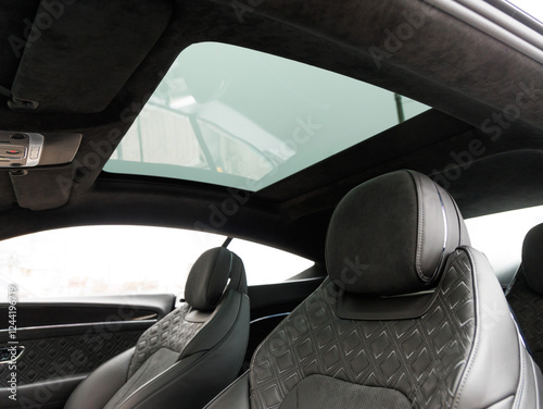 panoramic sunroof against the backdrop of luxurious leather seats in an expensive premium car