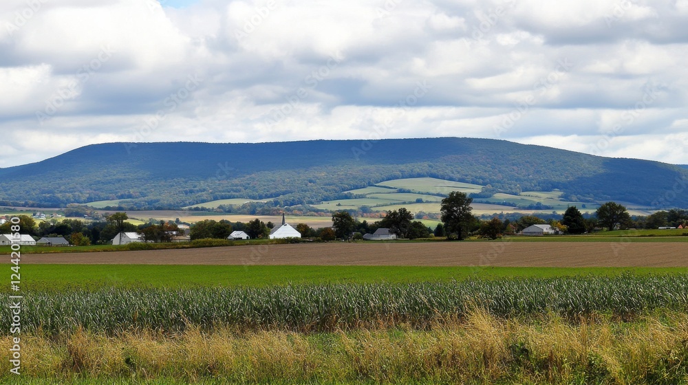 A Serene Rural Landscape with Rolling Hills and a Mountain Range in the Background A Serene Rural Landscape with Rolling Hills and a Mountain Range in the Background