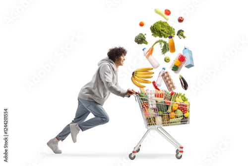 Young man running with falling food in a shopping cart, click and collect concept