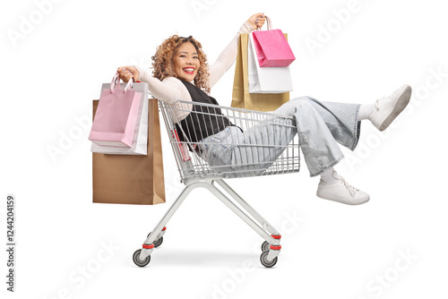 Asian woman sitting inside a shopping cart with many holding shopping bags