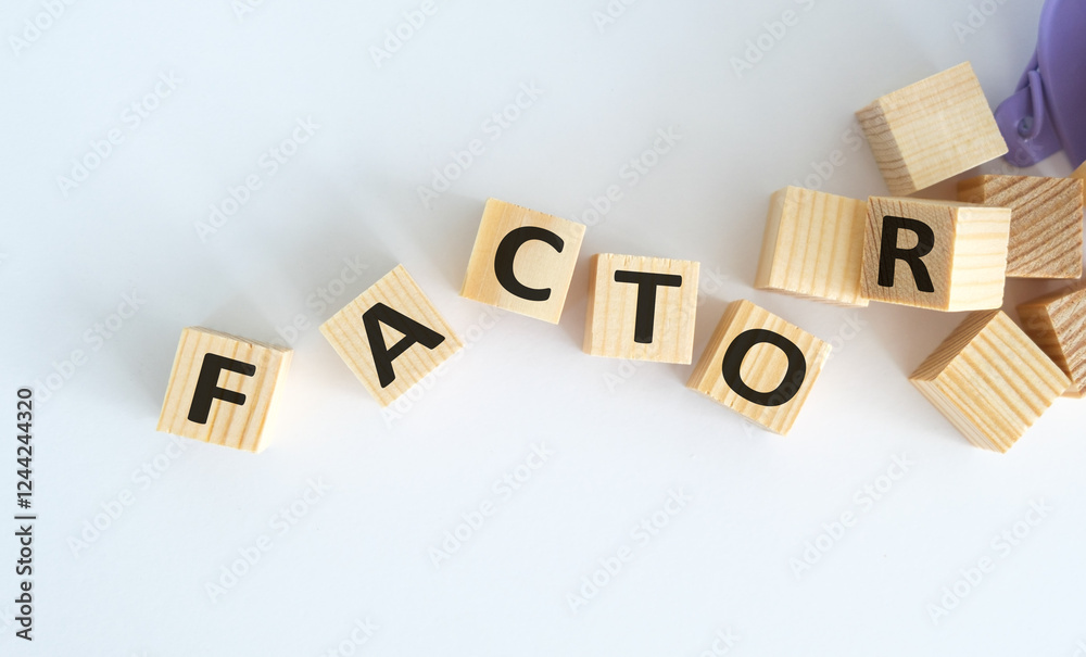 Obraz premium Factor text on wooden cubes on white background