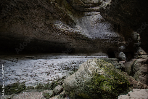 A view of a cave in a mountain gorge, the limestone rocks create a bizarre pattern photo