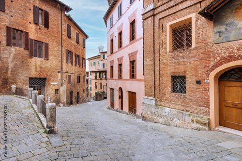 Fototapeta Naklejka Na Ścianę i Meble -  Old street in the historical center of Siena, the UNESCO World Heritage Centre unchanged for 13-14 centuries, with its medieval streets looked like in the early Middle Ages. Italy, 2019 