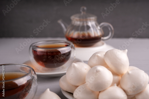 Wallpaper Mural photo Indulge in the Elegant Combination of Light and Fluffy Meringue Cookies Paired with a Rich, Aromatic Black Tea for a Perfectly Balanced Tea Time Experience Torontodigital.ca