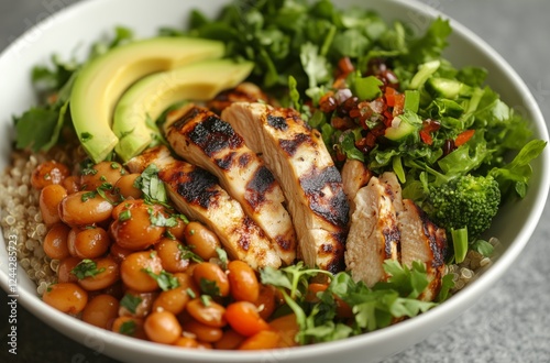 Grilled chicken bowl with quinoa, beans, and fresh vegetables for healthy eating