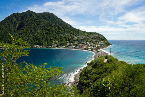 Fototapeta Naklejka Na Ścianę i Meble -  Breathtaking Aerial View of Scotts Head, a Coastal Village in Dominica, from Cachacrou Peninsula – Lush Green Hills, Turquoise Waters, Sandy Beach, where Caribbean Sea and Atlantic Ocean meet