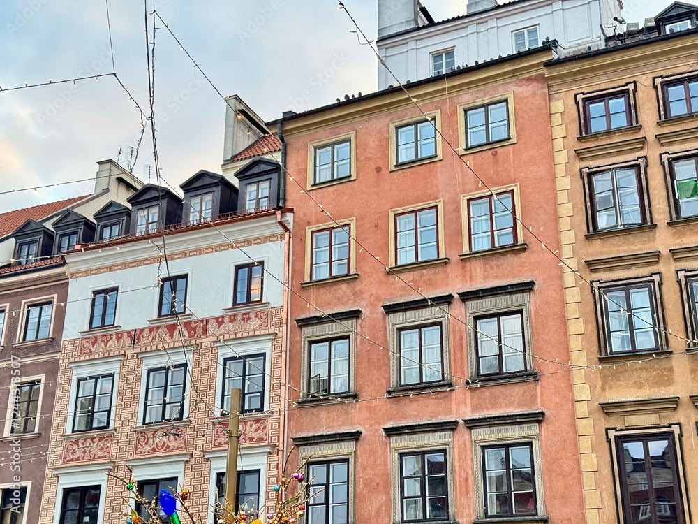 Fototapeta premium view of colorful buildings of Warsaw old town with christmas decorations on a cold december day 