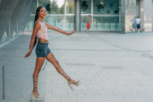 young woman model with miniskirt in summer on the street