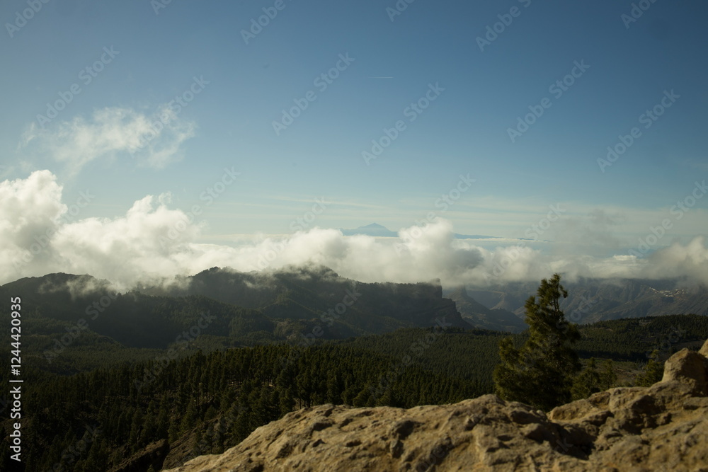 Mountainous landscape in Gran Canaria with a sea of clouds partially covering the slopes.