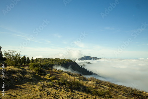 Mountainous landscape in Gran Canaria with a sea of clouds partially covering the slopes.