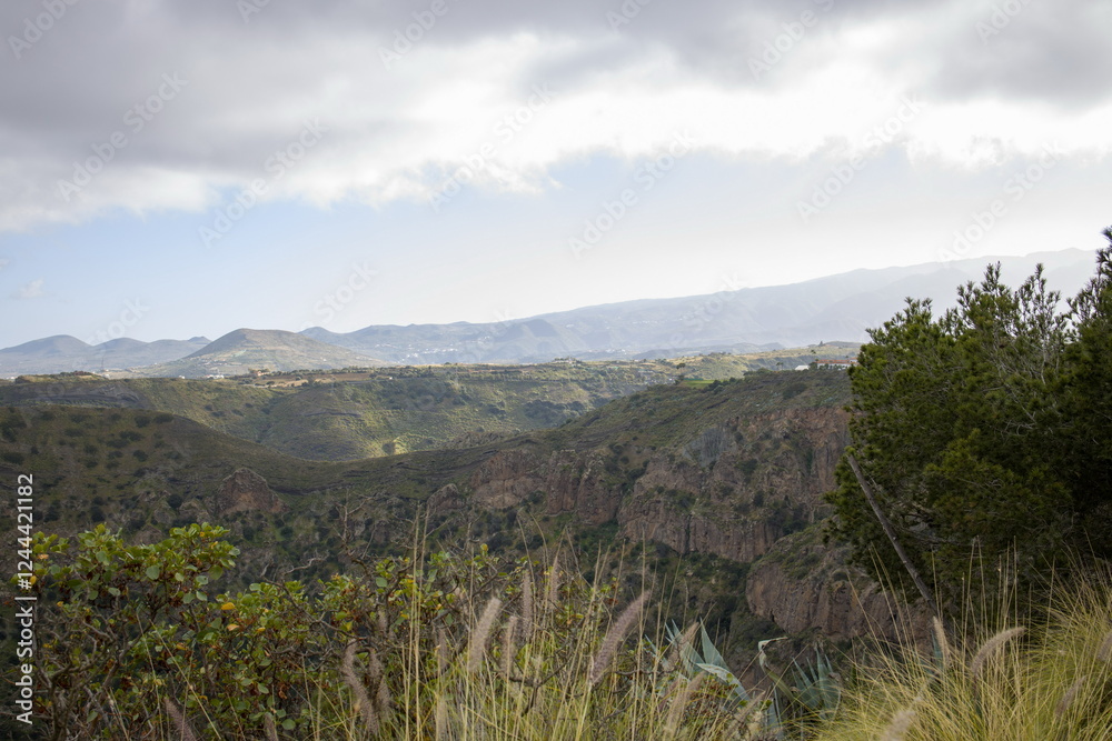 Rugged mountain landscape Bandama Caldera, Gran Canaria, with a prominent rock cliff or outcrop.