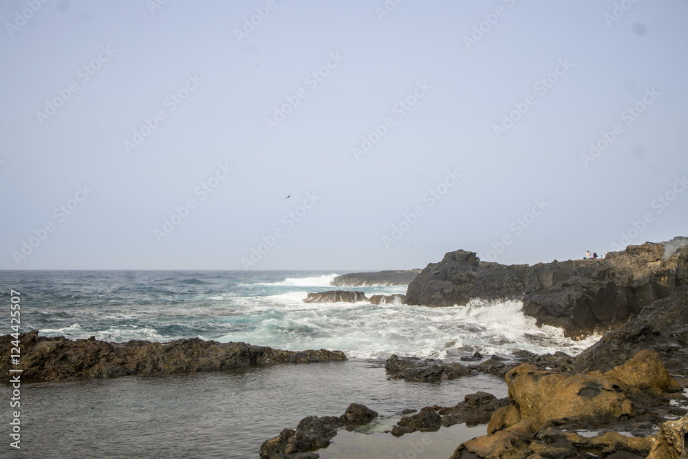 Waves crashing against a rocky shoreline in Gran Canaria.
