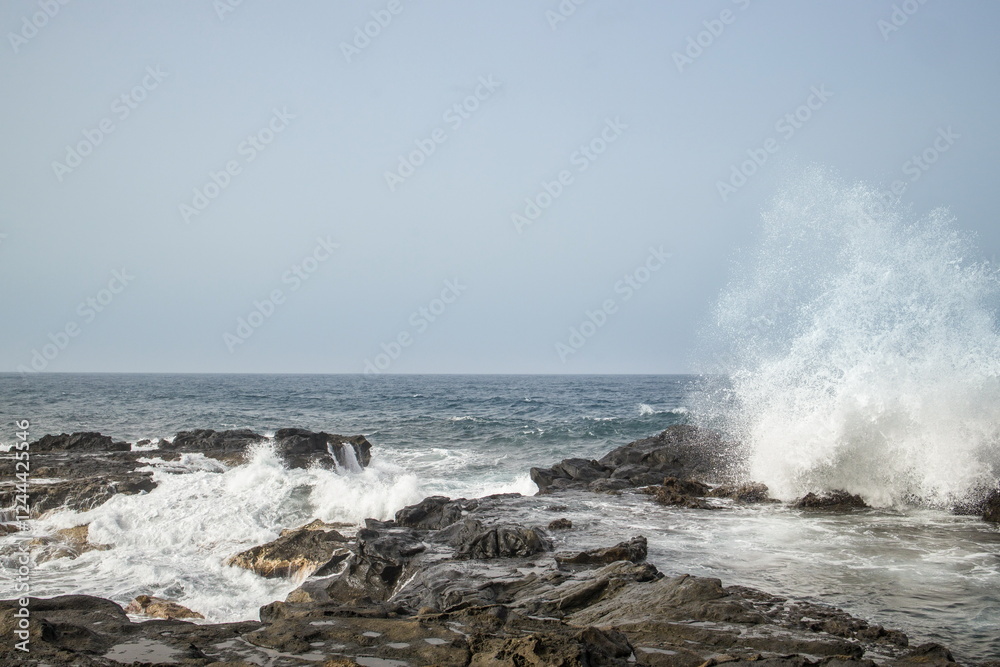 Waves crashing against a rocky shoreline in Gran Canaria.
